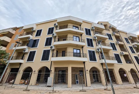 View of the facade and terraces of a residential building with a protective fence on the ground floor. - image 3