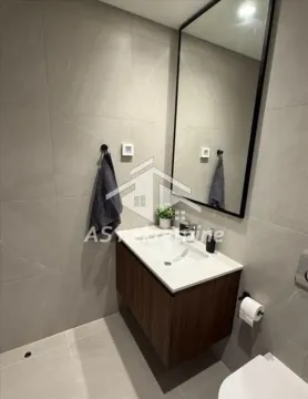 Modernly equipped bathroom with a washbasin, mirror, and gray tiles. - image 19