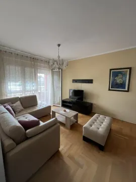 Comfortable living room with sofa, TV, and access to the balcony. - image 5