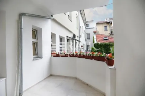 Covered balcony with a view of surrounding buildings and courtyard. - image 3