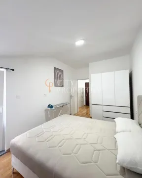 Bedroom with a double bed, white wardrobe, and hardwood flooring. - image 9
