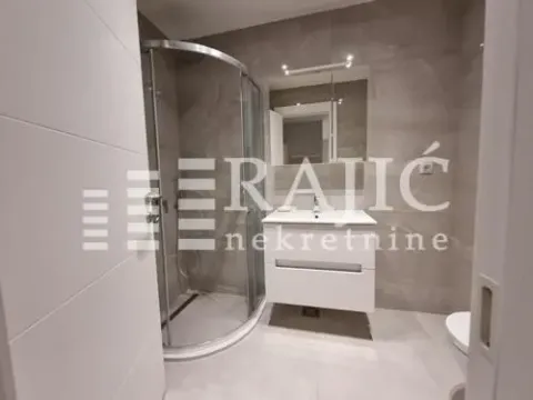 Modernly equipped bathroom with a shower cabin and sink. - image 9