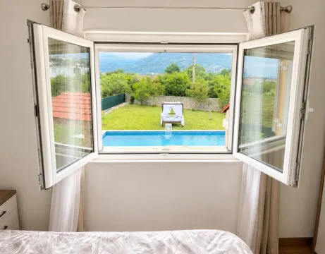 View from the bedroom window overlooking the yard with a swimming pool. - image 8