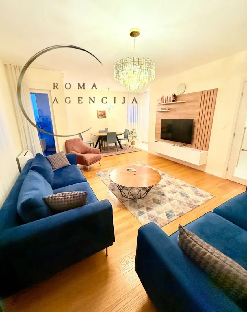 Spacious living room with a sofa set and a dining area in the background.