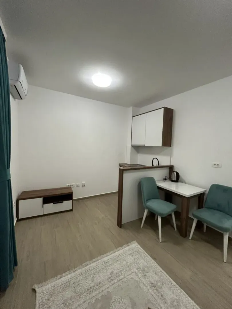 Smaller kitchen with a dining table and chairs integrated into the living area.
