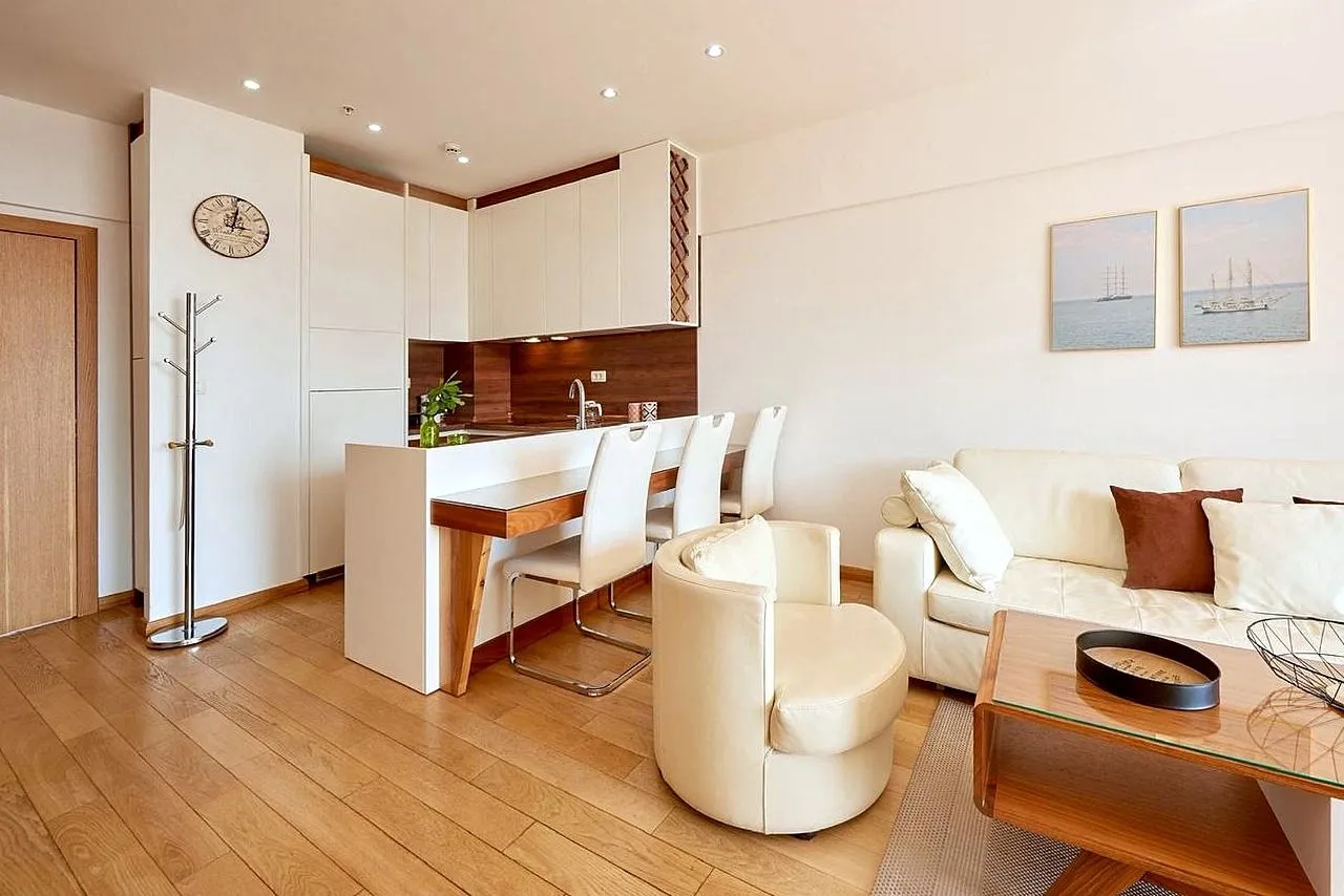 Living room with sofa set and dining bar counter adjoining the kitchen.