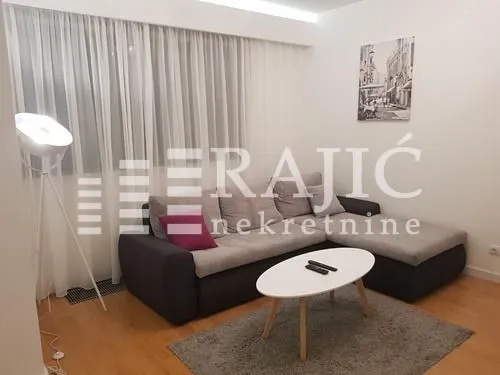 Living room with a sectional sofa, coffee table, and lamp.