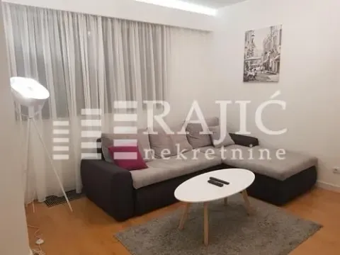 Living room with a sectional sofa, coffee table, and lamp. - image 4
