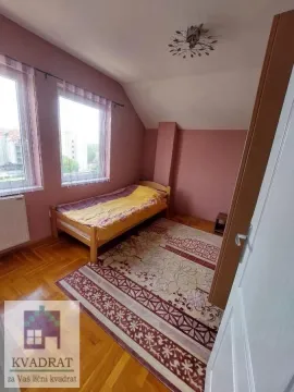 Small bedroom with a bed, parquet flooring, and two windows. - image 15