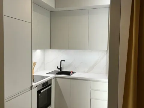 Modern white kitchen with built-in appliances and black details. - image 5