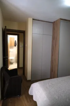 Bedroom with a built-in wardrobe and a view of the bathroom. - image 15