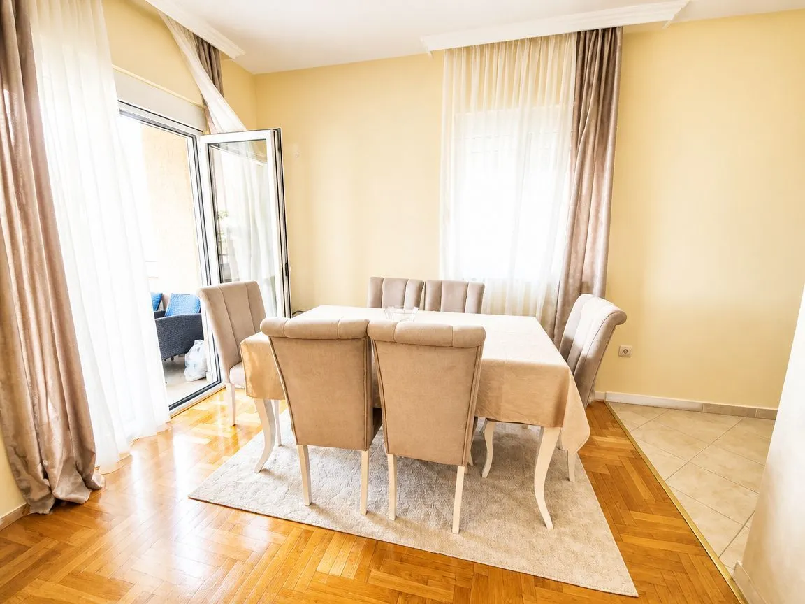 Dining area with a table, chairs, and access to the terrace.