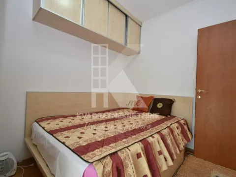 Smaller bedroom with a double bed and hanging cabinets. - image 2