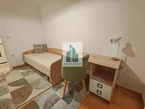 Small bedroom with a bed, a desk, and a rug. - image 15