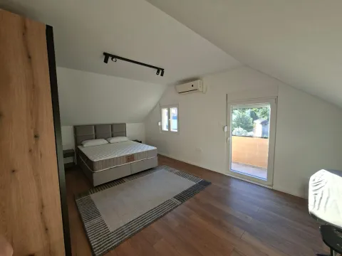 Attic bedroom with a double bed, wardrobe, and access to the terrace. - image 10