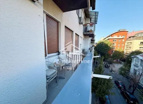 Long balcony with outdoor seating and a street view. - image 16