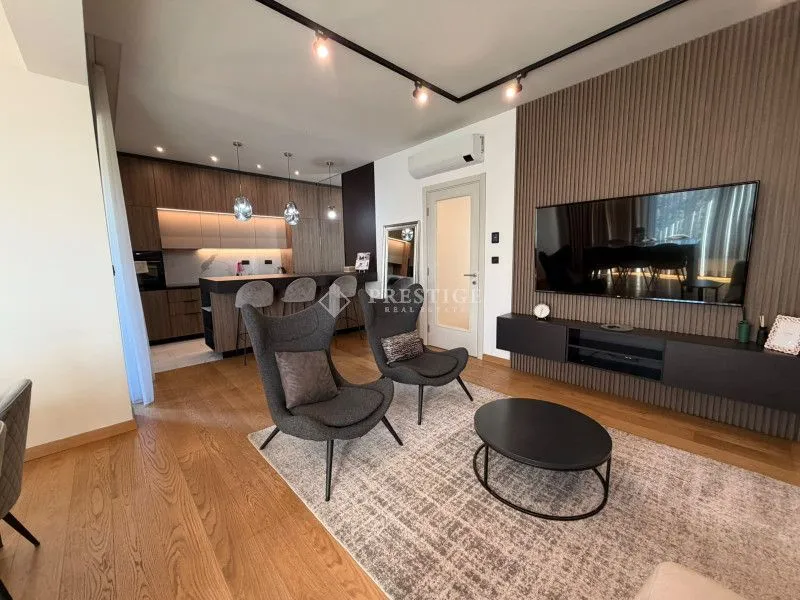 Modern living room with seating area and dining space.