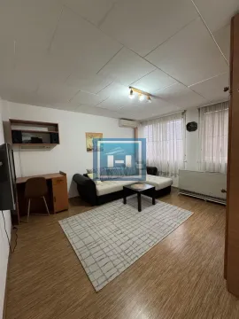 Living room with a sofa set, desk, and a rug. - image 8
