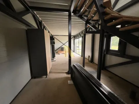 Interior of a building under construction with a metal structure and staircase. - image 11