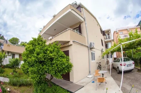 View of the exterior of the house with a courtyard, terrace, and parked car. - image 14