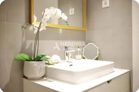 View of the washbasin and mirror in a furnished bathroom. - image 8
