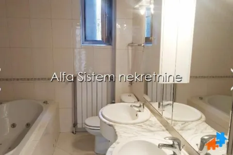 Bathroom equipped with a bathtub, washbasin, and toilet. - image 9