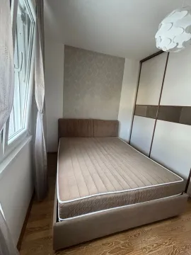 Bedroom with a double bed, wardrobe, and window. - image 7