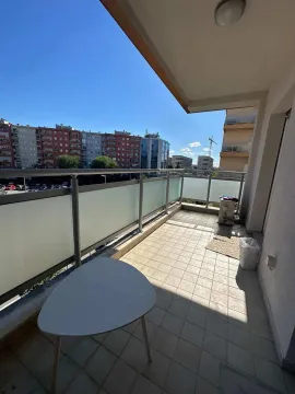 Spacious tiled balcony with a city view. - image 4