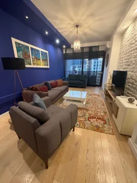 Living room with sofa set, television, and dining area in the background. - image 2