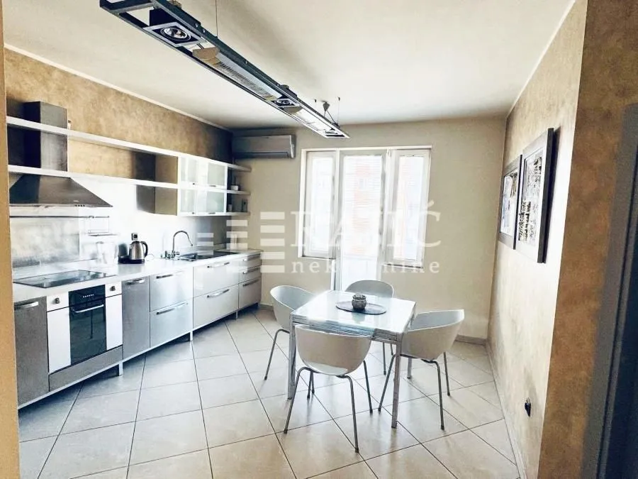 Modern kitchen with a dining area and built-in appliances.