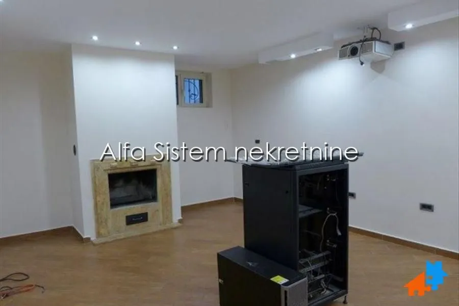 Living room with a built-in fireplace and projector.