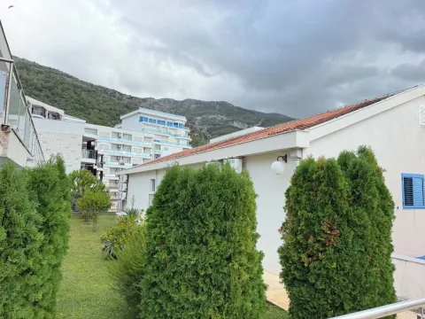 View of the building's courtyard with landscaped greenery and surrounding buildings. - image 5