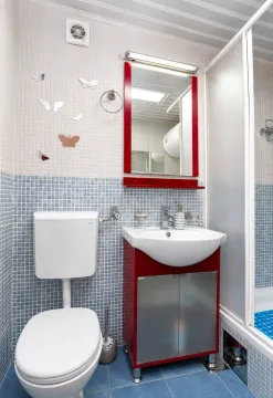 Bathroom with a toilet, washbasin, mirror and shower cabin. - image 4