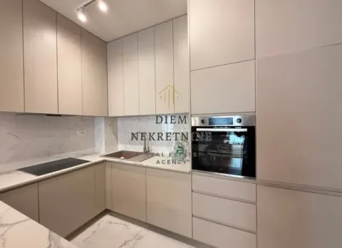 Modern kitchen with built-in appliances and marble countertops. - image 9