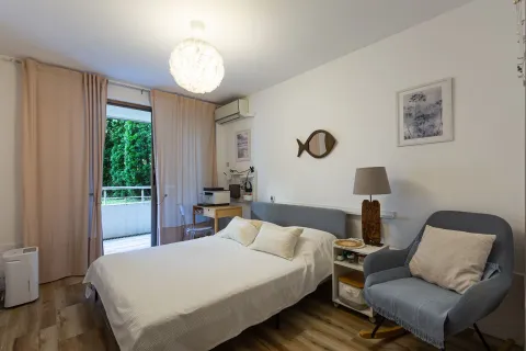 Namještena spavaća soba sa bračnim krevetom, foteljom i izlazom na terasu. - image 13