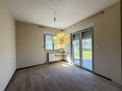An empty room with a window and balcony doors overlooking the yard. - image 7
