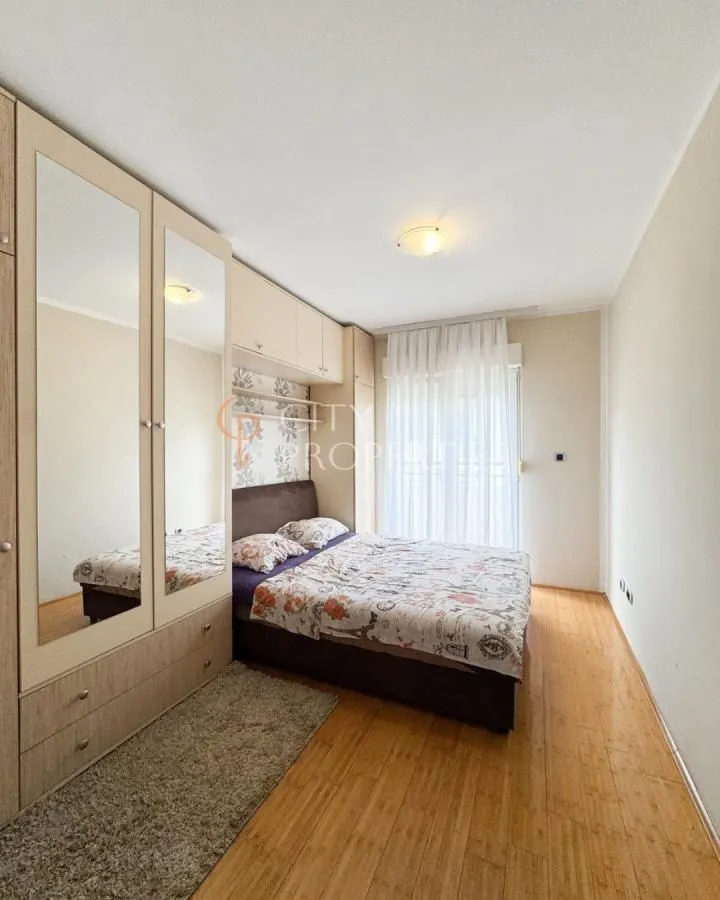 Bedroom with a double bed, large wardrobe with mirrors, and access to the terrace.