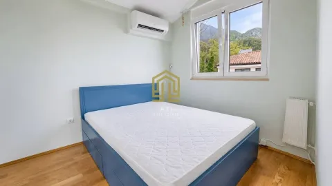 Bright bedroom with a blue double bed and an air conditioning unit. - image 6