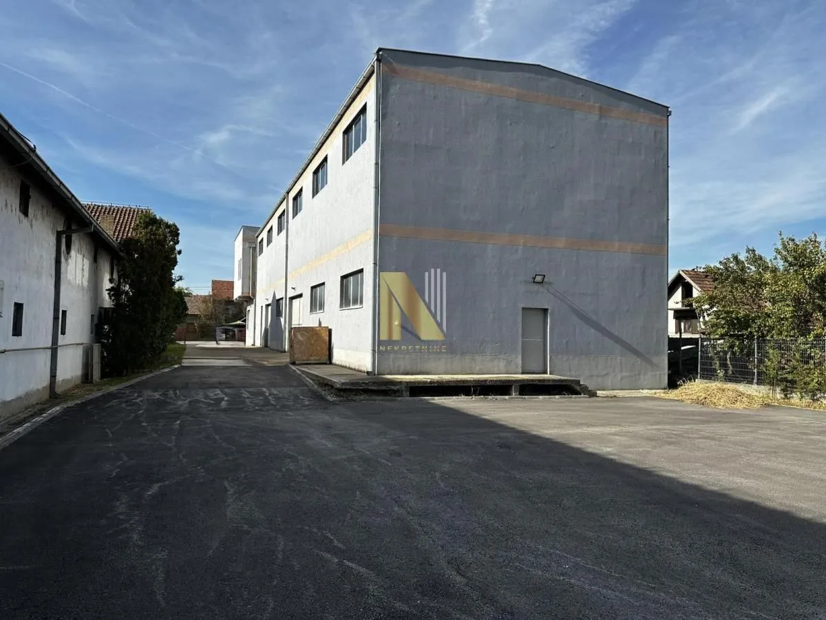 View of the exterior of a commercial building with an asphalted courtyard.