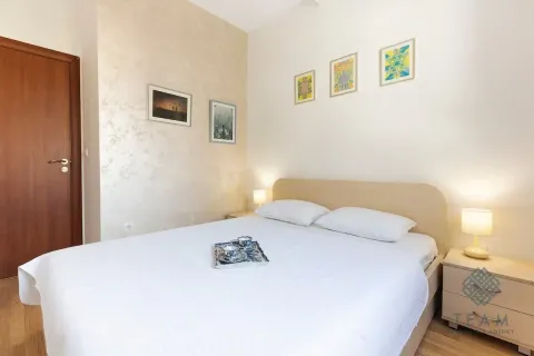 Furnished bedroom with a double bed, bedside tables, and wall art. - image 10