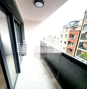 Spacious balcony with a view of surrounding buildings. - image 8