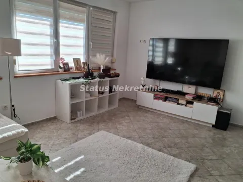Dnevna soba sa velikim televizorom, komodom i prozorima. - image 10