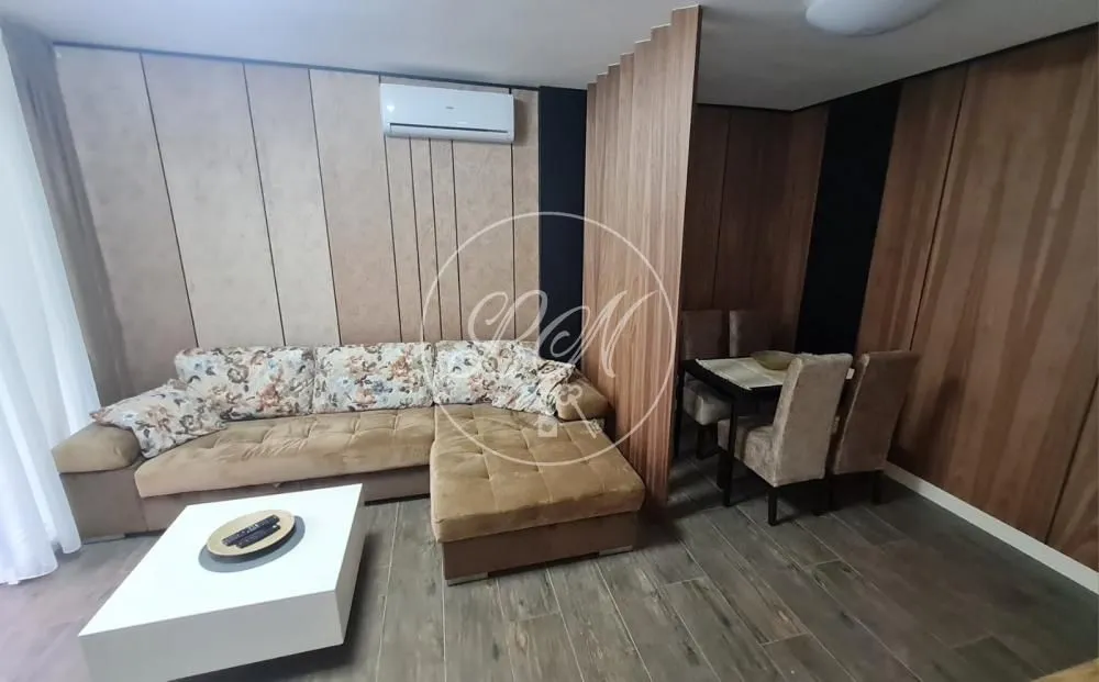 Living room with a corner sofa, coffee table, and dining area.