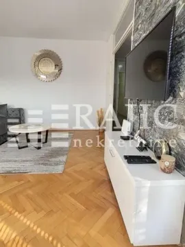 Living room with TV, console, and furniture. - image 4