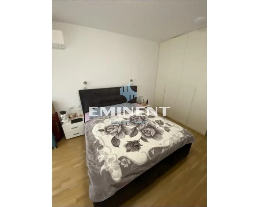 Bedroom with a double bed, nightstand, and fitted wardrobe.