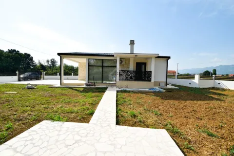 Exterior view of a single-story house with a yard and a pathway. - image 7