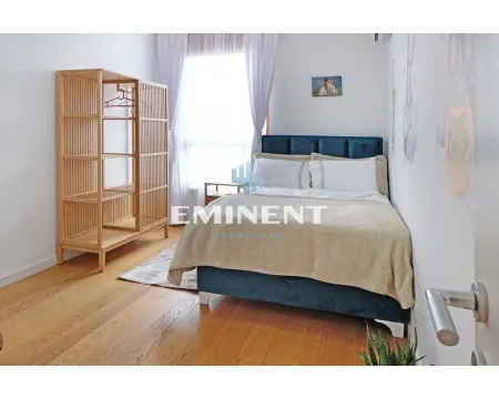 Furnished bedroom with a double bed and a wooden wardrobe. - image 10