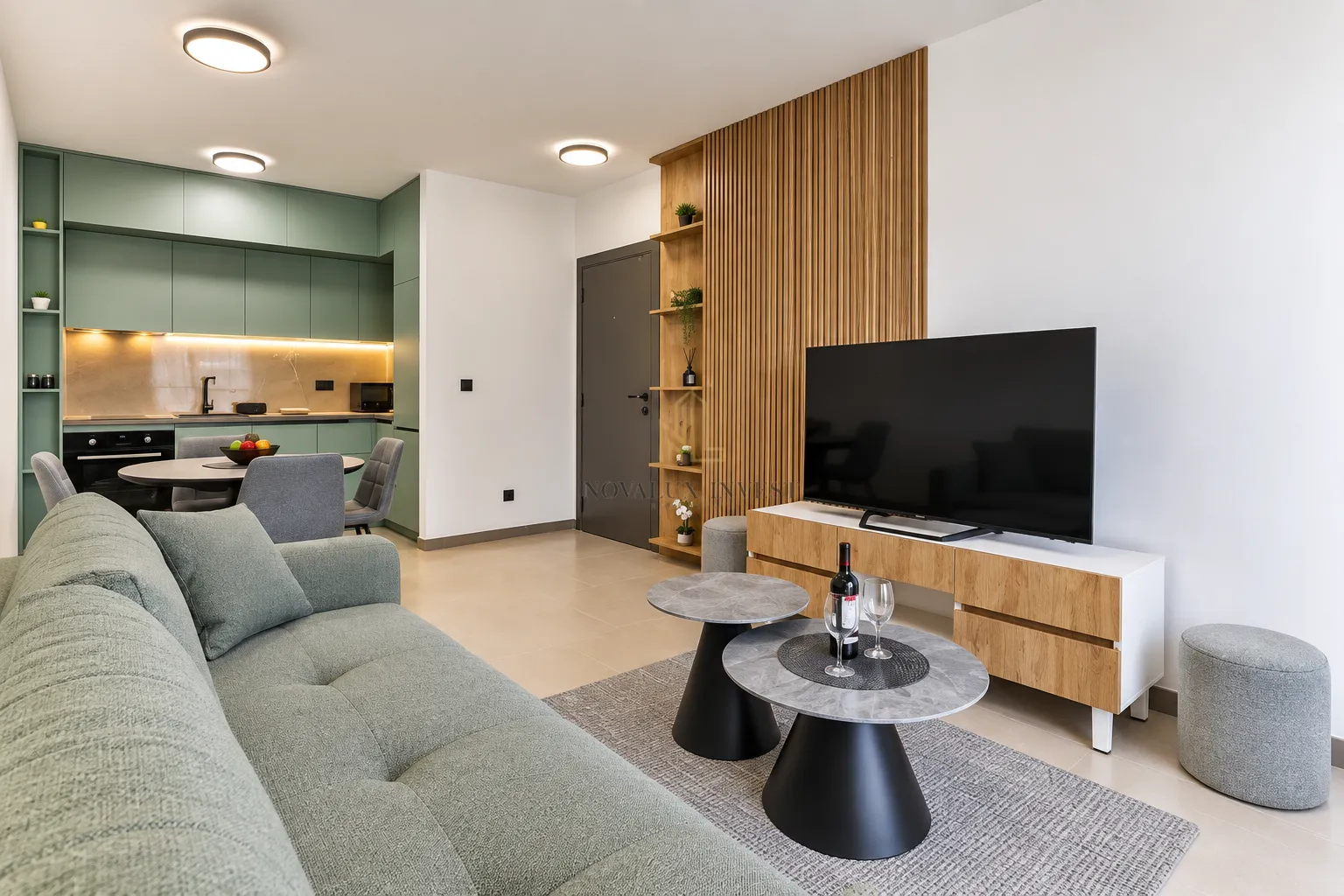 Living room with sofa, television, and dining area in the background.