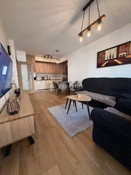Spacious living room with an open-plan kitchen and dining area. - image 2