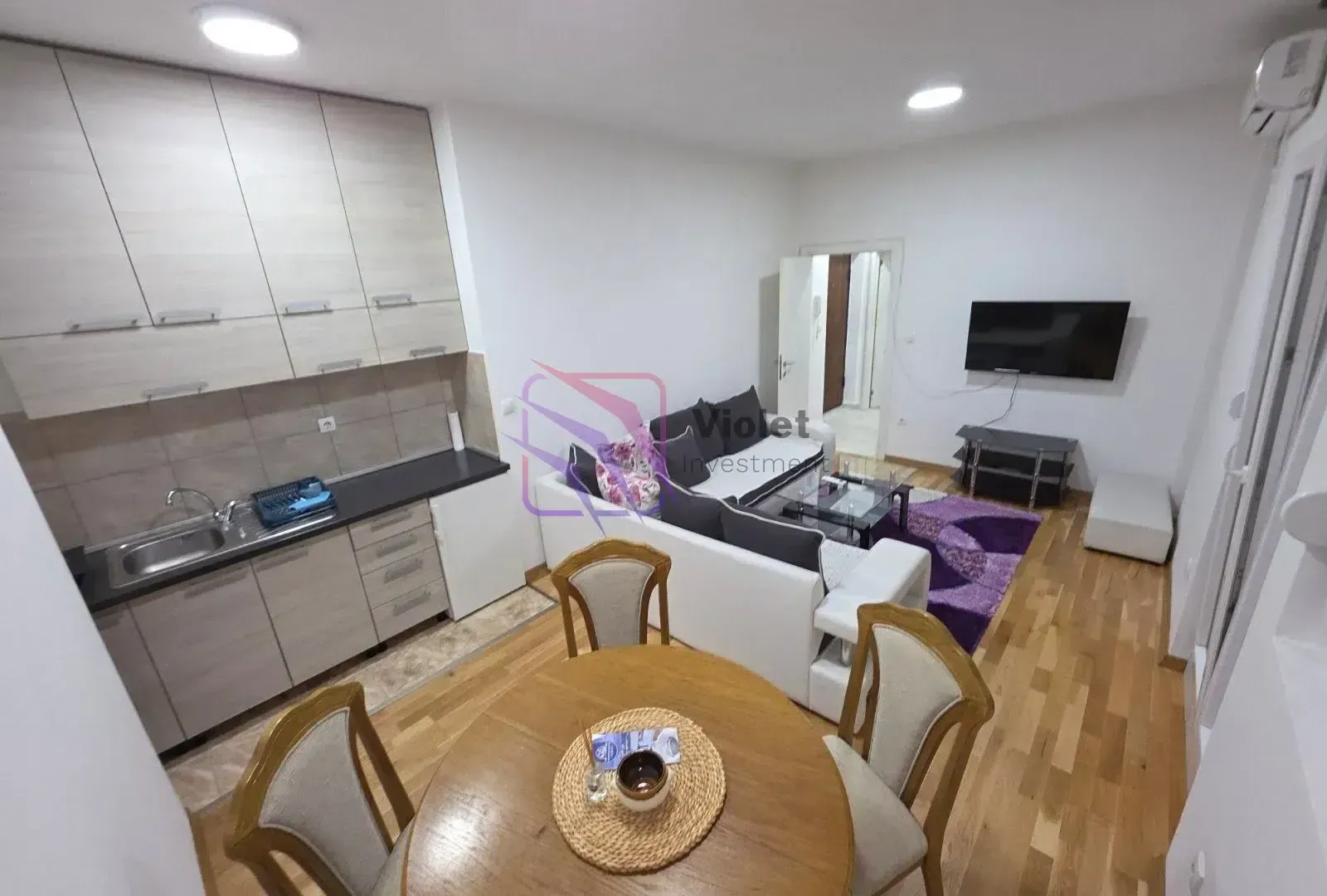 Open-plan living room with dining area and kitchen.